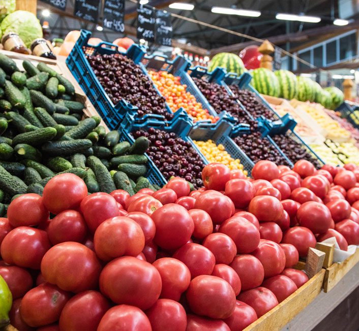 a sign labeled local products, with vegetables near it