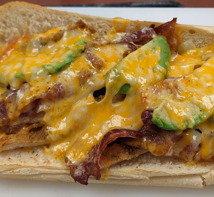 a deli sandwich with melted cheese
