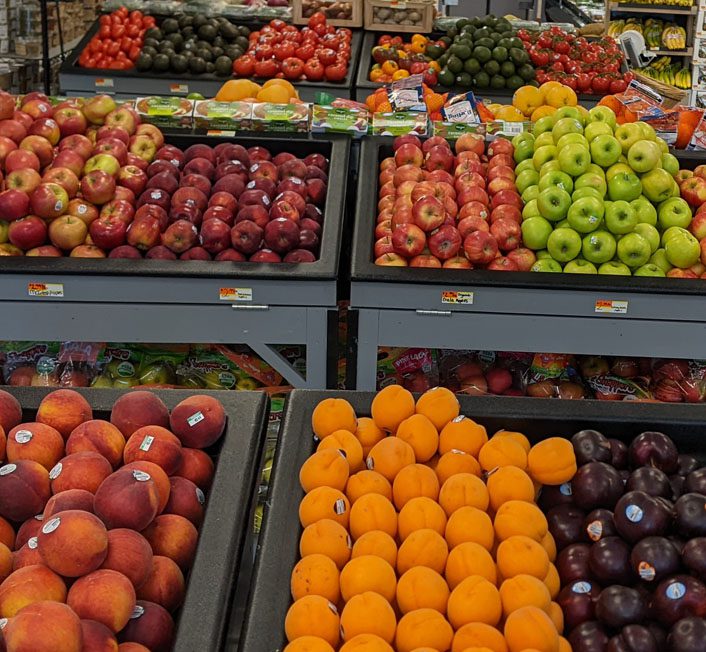 a sign labeled local products, with vegetables near it