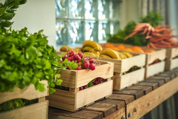 Fresh produce in wooden crates in a wooden table